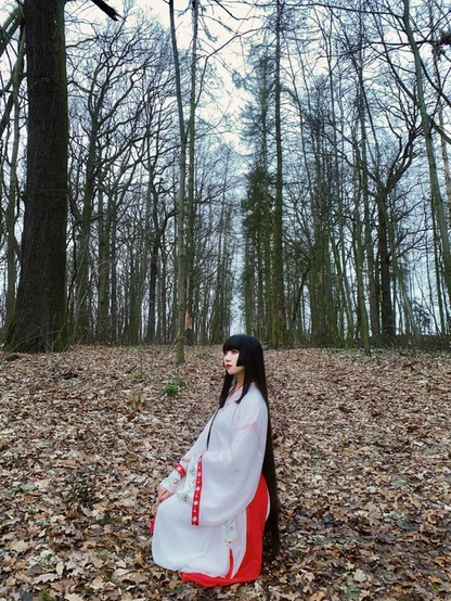 Miku sitting in a winter forest