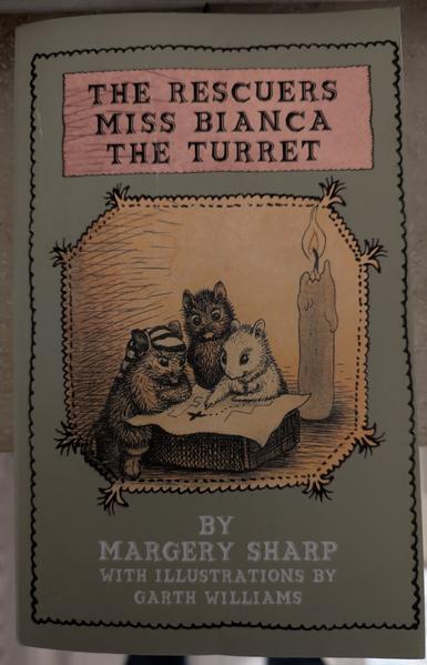 Book cover listing the three names of the combined books:
"The Rescuers", "Miss Bianca" and  "The Turret" by Margery Sharp with illustrations by Garth Williams.

The book is kept in a pastel green. The cover image shows three small mice standing on their hind legs looking at a tiny map on a kind of tiny table. Obe mouse is white and points at a point of the map, another is black and the third one is also mostly black and either wears some kind of limp, pointed hat or a kind of woven, ponytail hairstyle.

The room in which they're reading the map is lit with a candle about twice the upright size of the mice.