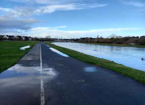 Segregated cycle and foot paths and flood relief channel.
