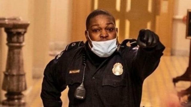 A Capitol Police officer, Eugene Goodman, gestures at a group of protestors. He successfully led them away from Congress people just yards away. January 6, 2021