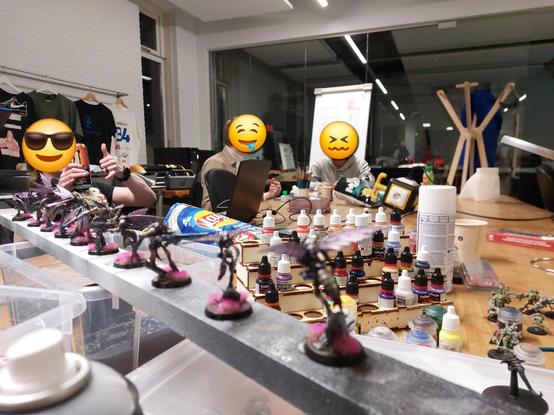 Three Muppets in the background making faces and sporting Monster Energy drink because he's a late teen. Bottles of Vallejo paint and wasp dudes in front