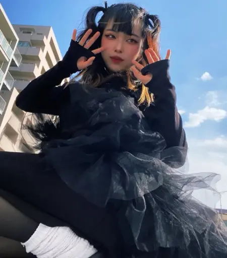 Menma peering down. Dressed in black