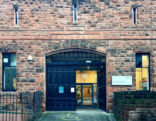 The castle-like entrance to a red sandstone late Victorian building.