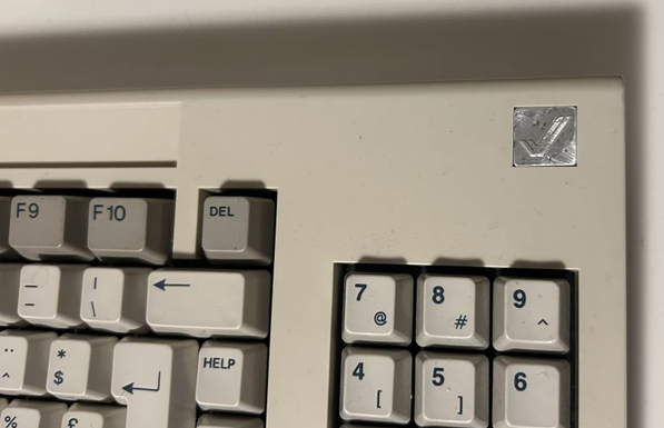 An Amiga 1000 keyboard with a ruined metal batch