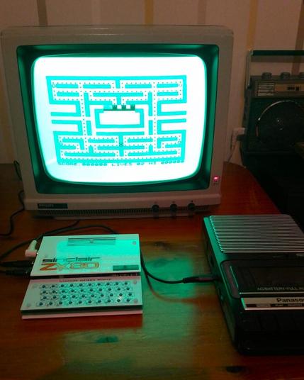 Gameplay screen of PacMan on the ZX80 clone computer (Minstrel 2). It is being displayed on my vintage Philips green screen CRT monitor. In front is the computer and next to that is my cassette recorder which was used to load the game into the ZX80. I'm not actually playing the game, as I was holding the phone to take this photo.
