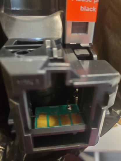A closeup of a toner cartridge showing its drm restricted chip