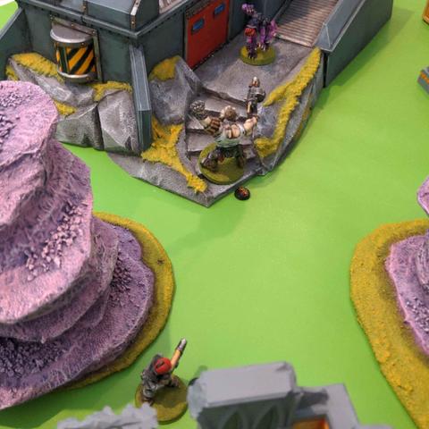 A guardsman and an ogryn face off against a genestealer in an attempt to capture a bunker