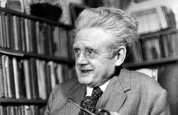 2) A black-and-white image of Hugh MacDiarmid at his home in 1968, aged 76. He has straight grey hair which is pushed back and upwards from his face, at least 3 inches. He is looking off to his right and smiling / talking. There are shelves fo books in the background of the picture.

Source: https://www.heraldscotland.com/opinion/19648152.hugh-macdiarmid----poet-communist-nationalist-breathed-life-scots-leid/