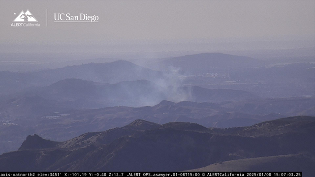Smoke rising over a garbage dump