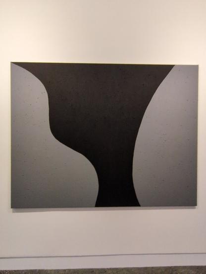 The first of a series of grey on black paintings by Matthew Harris depicting a sacred rock formation called Yeddonba near Wangaratta, titled "Just us two". Here, there are now two curvy silver shapes on the left and right of the black canvas.