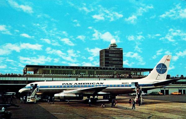 Plane is parked at a gate under blue skies