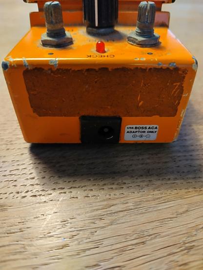 Photo of the back of a Boss DS-1 with a decal that says "Use Boss ACA adapter only". This could indicate this is an early Taiwanese version with the unchanged PCB design.