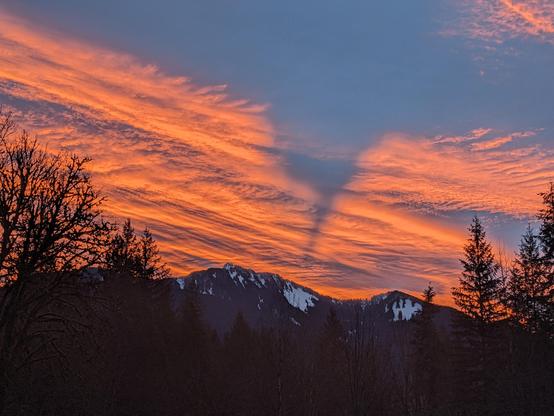 Snow covered Prairie mountain backlit by the dawn.