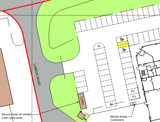 Plan showing a car park accessed from the road, with cycle racks in the bottom left corner, far from the door roughly centre-right.