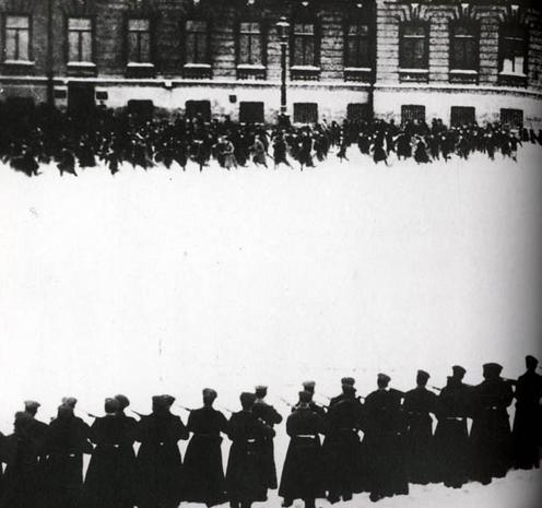 Still from the Soviet movie Devyatoe Yanvarya ("9th of January") (1925) showing a line of armed soldiers facing demonstrators at the approaches to the Winter Palace in St Petersburg. Public Domain, https://commons.wikimedia.org/w/index.php?curid=112826