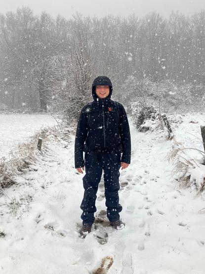 Job standing in snowstorm