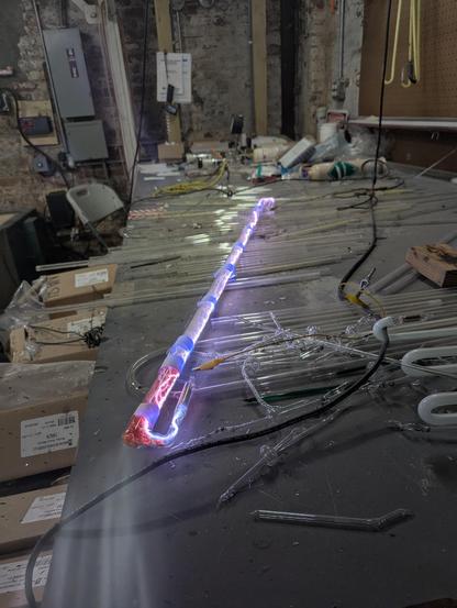 "bombarding" the tube with the aging transformer. The idea is to use the most amount of air as you can while still maintaining an arc. The air is a poor conductor and has lots of resistance, so it generates heat when you put current through it. Like sandpaper. The aging transformer only has 60ma of current- so its a gentle sander. The white arc there is a mostly clean ish air arc.