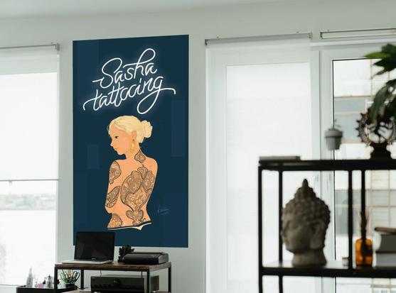 picture of a tattoo shop with a big banner on the wall with an illustration of a woman dressed in a flower/ornament tattoo.