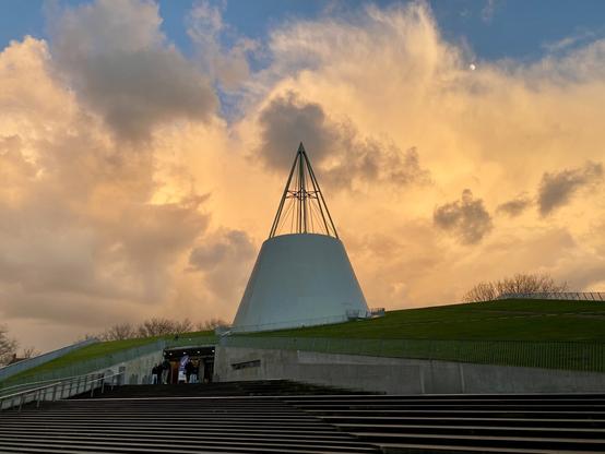 The iconic TU Delft library, at sun set and moon rise, with golden clouds