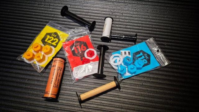 A collection of various adapters and film spools from various vintage film formats.