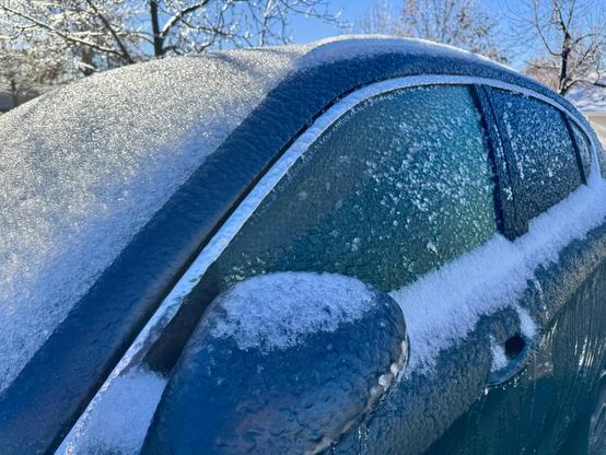 A vehicle is covered with a quarter inch of ice after a winter storm.