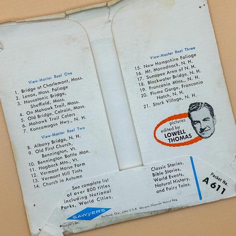 The image displays the back cover of a View-Master packet, featuring a list of scenic locations in Massachusetts and New Hampshire. It includes three reels with titles such as "Bridge at Charlemont, Mass." and "New Hampshire Foliage.”