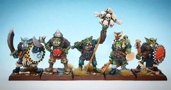A group of five intricately detailed orc miniatures stand in formation. One holds a standard, while others wield axes and shields, set against a blue background.