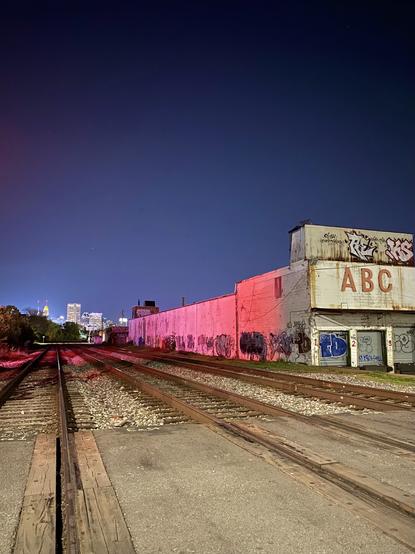 Railroad tracks at midnight city scape in background Baltimore Maryland