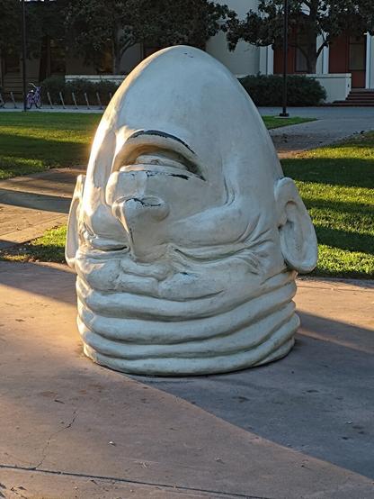 An upside down smiling head statute