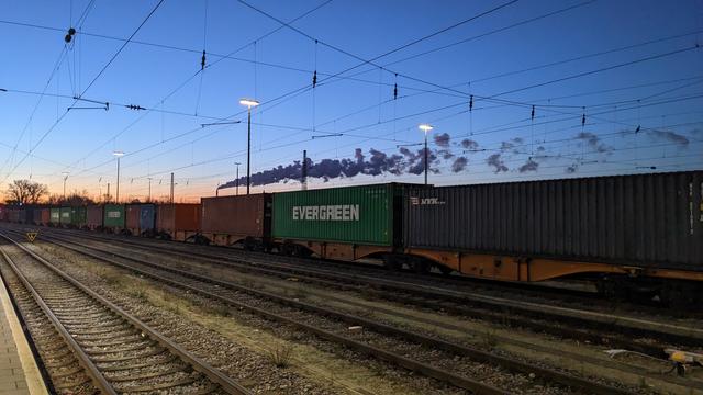 Sunrise in a railyard with a cargo train.