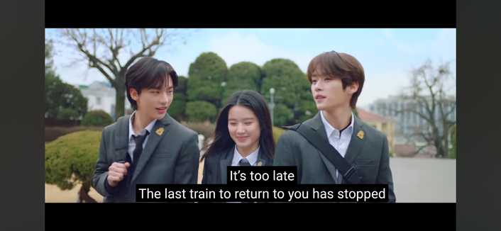 Hyunjin and Lee Know in school uniforms, with a girl in a school uniform in between them. Caption: it's too late / the last train to return to you has stopped
