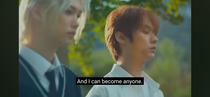 Felix and Lee Know in school uniforms. Lee Know has a mark (maybe a bruise?) on his chin. Caption: and I can become anyone