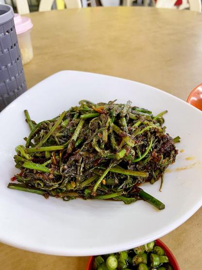A plate of fern shoots stir-fried in spicy shrimp paste