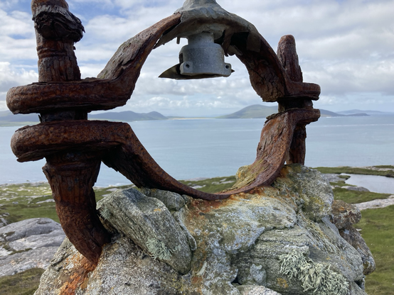 Looking through the remnants of a light fitting on the mountain over the ocean