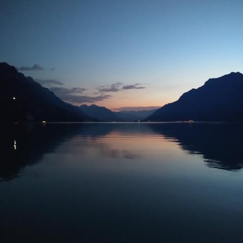 Sunset on Lake Brienz, neighboring mountains mirrored on the water surface