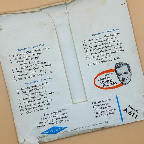 The image displays the back cover of a View-Master packet, featuring a list of scenic locations in Massachusetts and New Hampshire. It includes three reels with titles such as "Bridge at Charlemont, Mass." and "New Hampshire Foliage.”