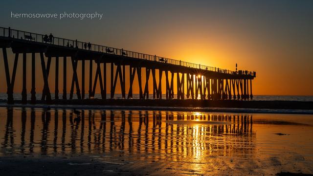 Sun sets behind the Hermosa’s beach pier
