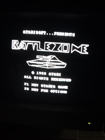 Atarioft Battlezone title screen. "Battlezone" written in big vector drawn letters with a vector tank below.