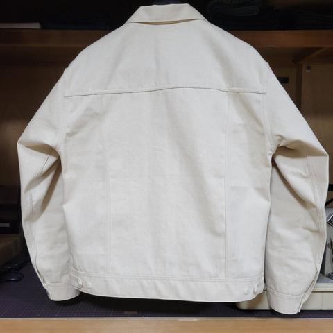 back view of an off-white sateen jacket