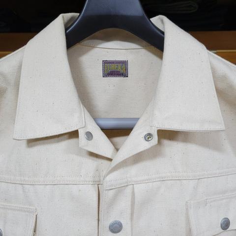 closeup of the collar on an off-white sateen jacket