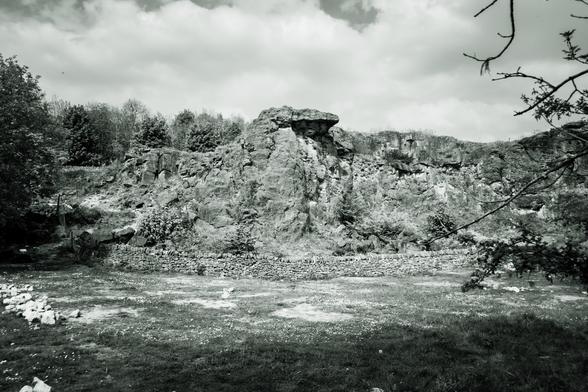 Black and white photo of a rock formation that is part of an old quarry.