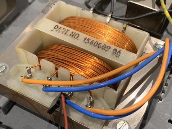 A transformer showing orange copper windings.