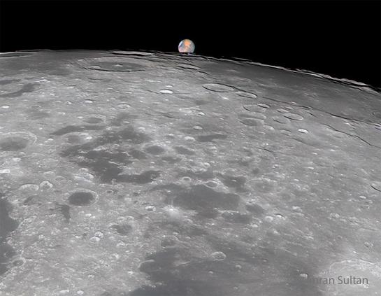 Earth's moon is shown in full phase. At the top of the frame, appearing much smaller, is the more distant planet Mars.