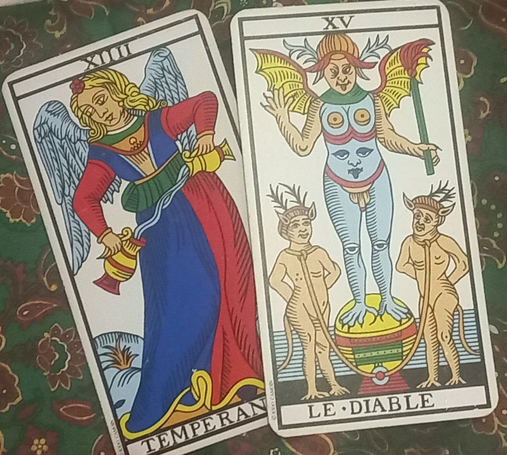 Two Tarot cards, Temperance and The Devil, next to each other