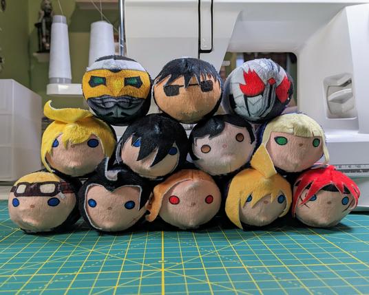 a stack of freshly finished plush featuring a wide variety of faces