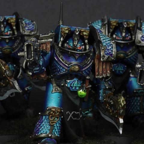 Close up of the squad leader, he's equipped with a volkite charger, a power axe, a venom sphere and a power dagger.