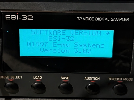 Photo of the display when machine turned on. It shows the software version "ESi-32, (c) 1997 E-mu Systems, version 3.02"

Originally green, but now sporting a blue backlight. 

The characters are a bit faded though but that part I haven't got a replacement for. Or perhaps I do, but I need to pull the thing apart again, so I'll look at that in another 2 years LOL