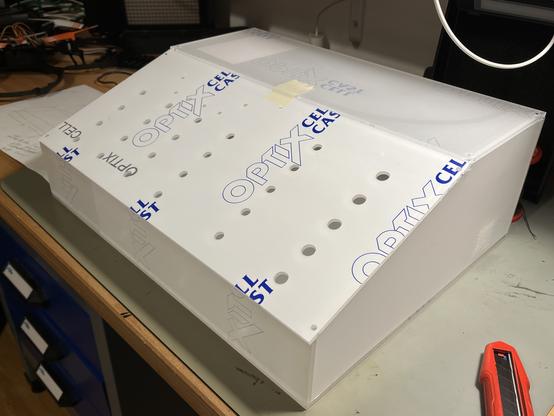 Acrylic parts with protective foil just stacked on each other. It’s basically a box with flattened front and holes for controls.