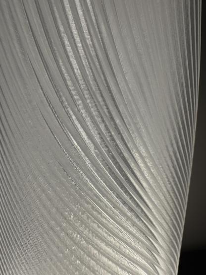 Close up of a 3D printed lamp shade showing the curvy design.