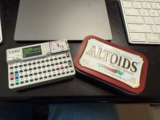 A cardputer running Forth next to an Altoids tin (for scale)